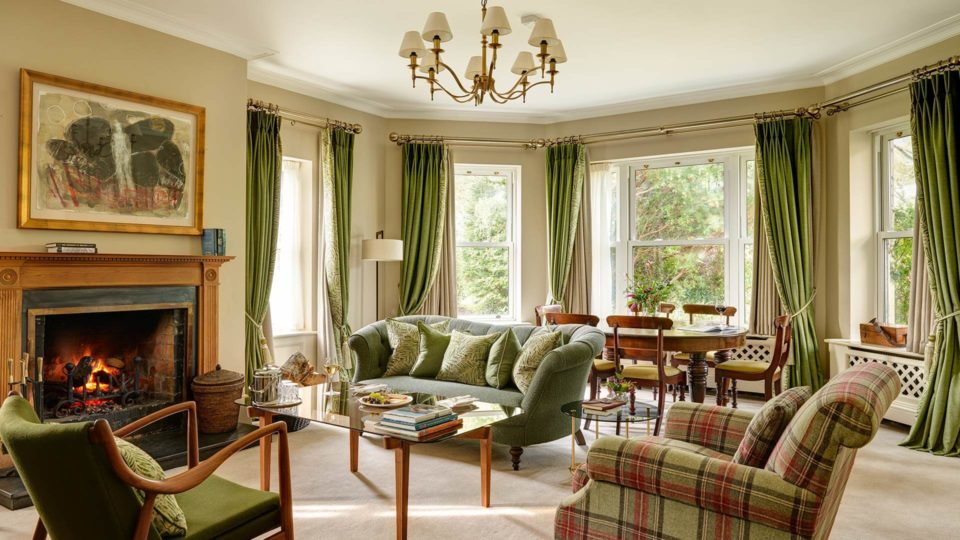 Bay Suite Lounge Room with couch, armchairs and fireplace