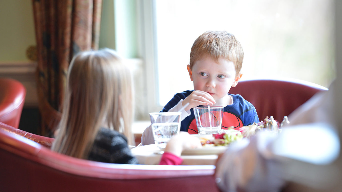 Two young children enjoying a meal