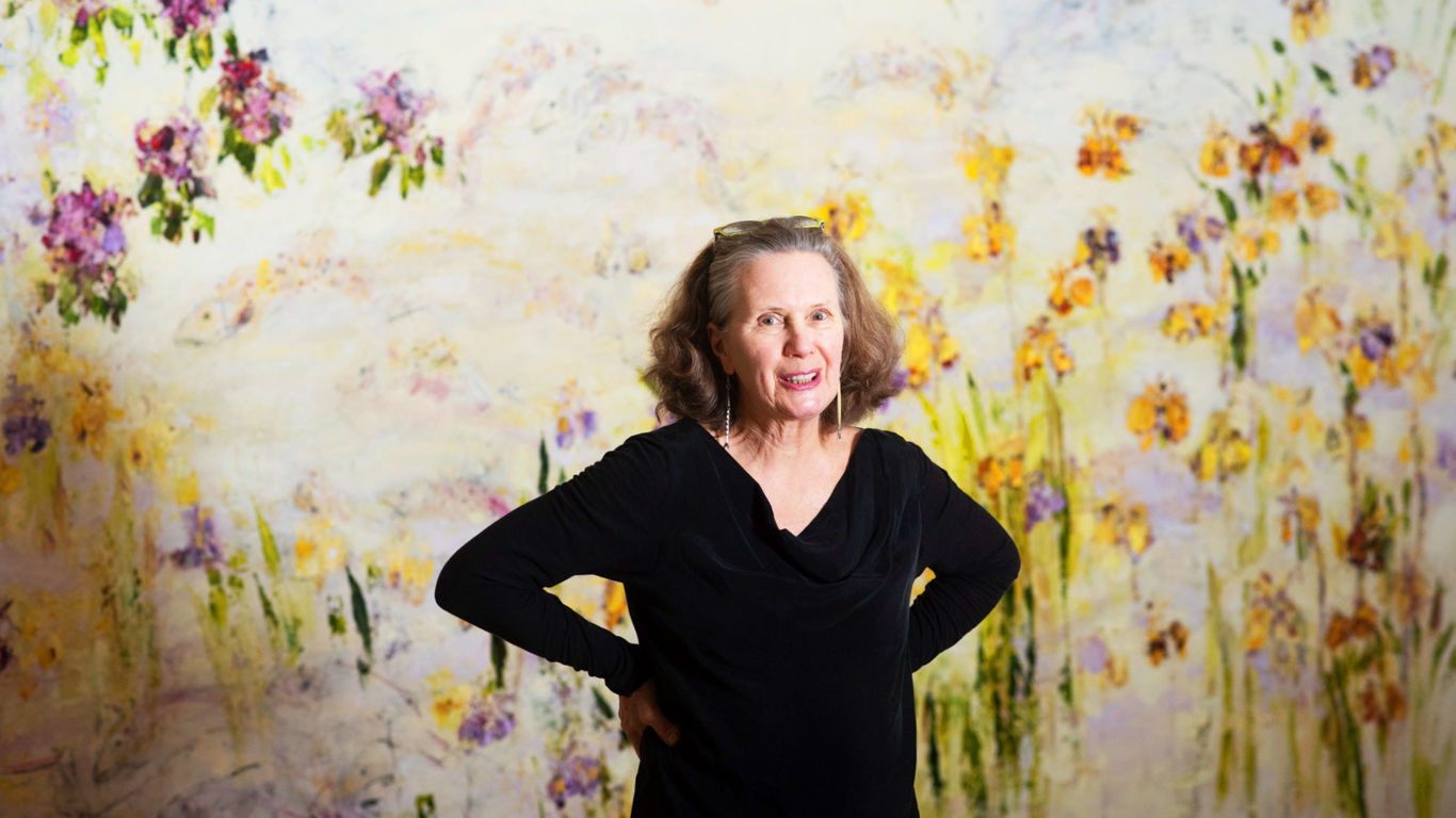 Artist Christine Bowan in front of her work