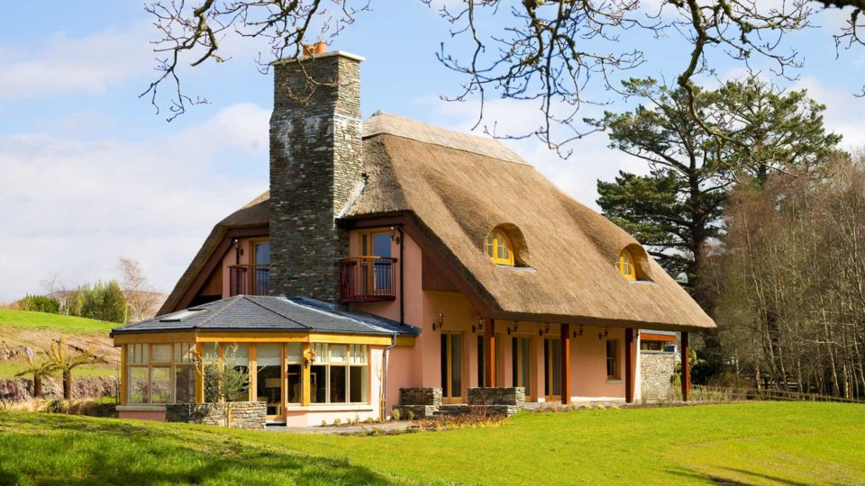 Large pink thatched cottage
