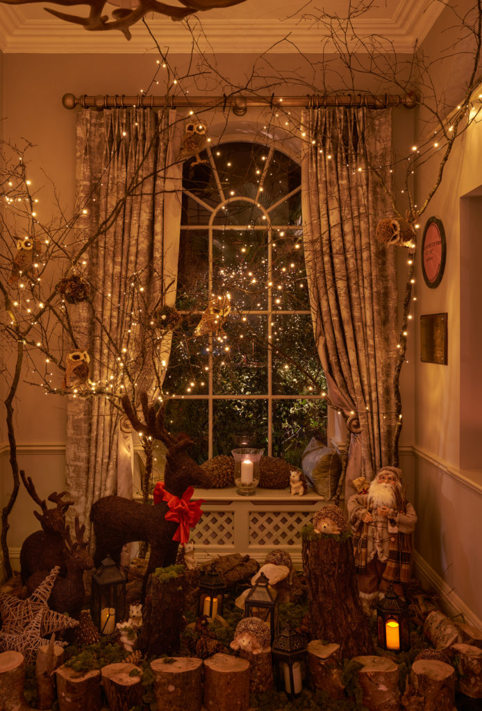 Christmas decorations aglow around a picture window
