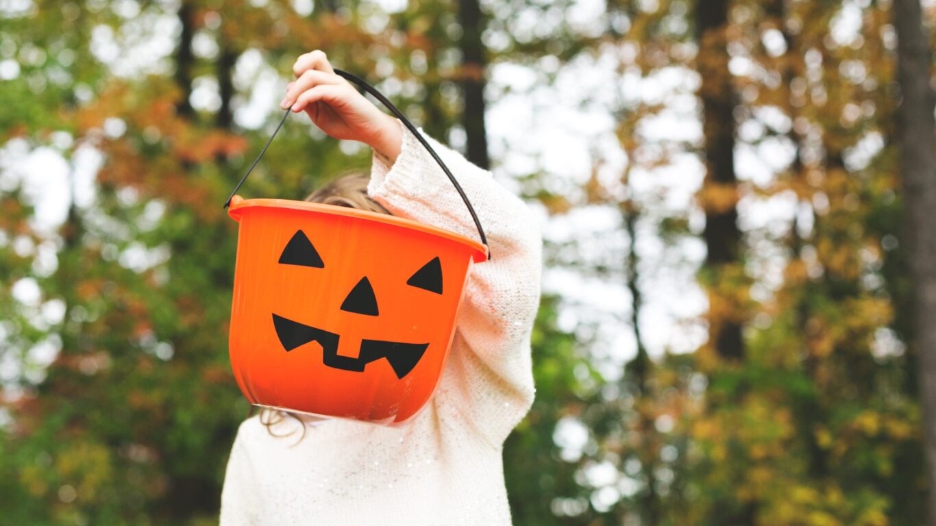 child-holding-jack-o-lantern