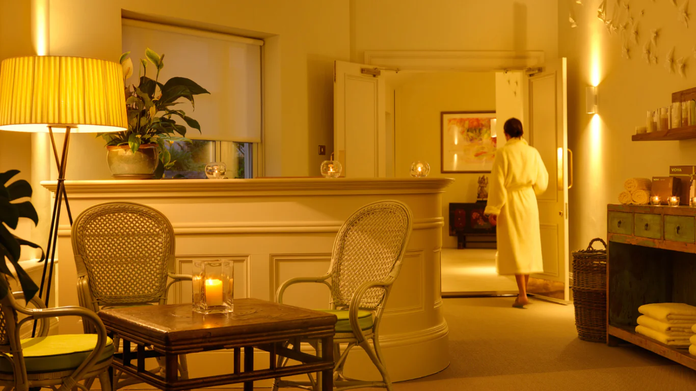 Luxurious hotel spa with warm lighting, cosy seating, relaxing candles, plush towels, and a serene atmosphere for guests.