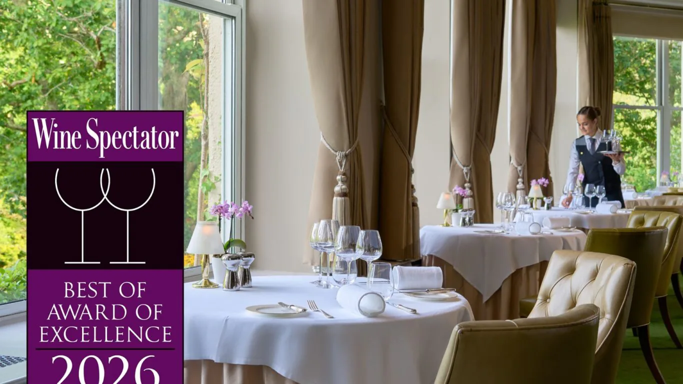Elegant hotel restaurant with scenic garden views, award-winning wine selection, cosy seating, and attentive service.