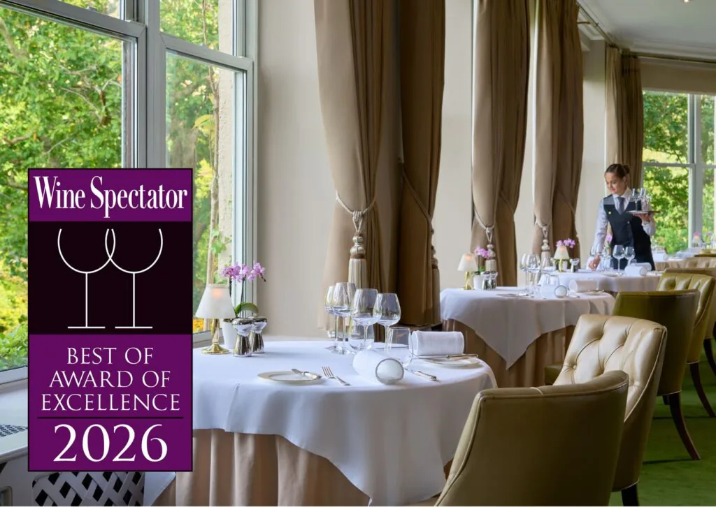 Elegant hotel dining room with large windows, plush chairs, and attentive service, offering a tranquil dining experience.
