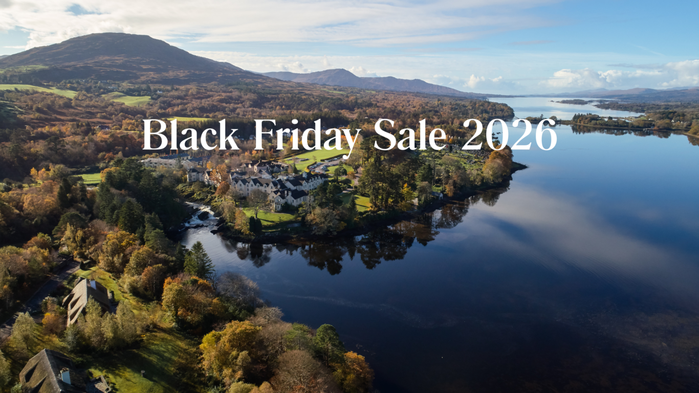 Lakeside hotel with scenic mountain views and lush autumn foliage, perfect for a tranquil getaway. Black Friday Sale 2026.