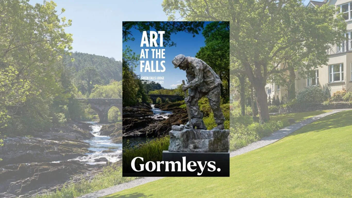 Serene riverside view with lush greenery and a sculpture at Sheen Falls Lodge, perfect for art lovers seeking relaxation.