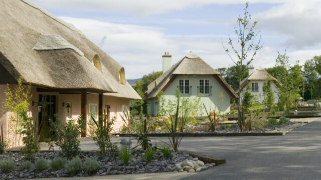 Charming thatched cottages surrounded by lush gardens, offering a peaceful retreat for guests at our countryside hotel.