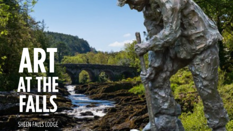 Sculpture near Sheen Falls Lodge, lush greenery, and serene river with stone bridge, perfect for art lovers and nature enthusiasts.