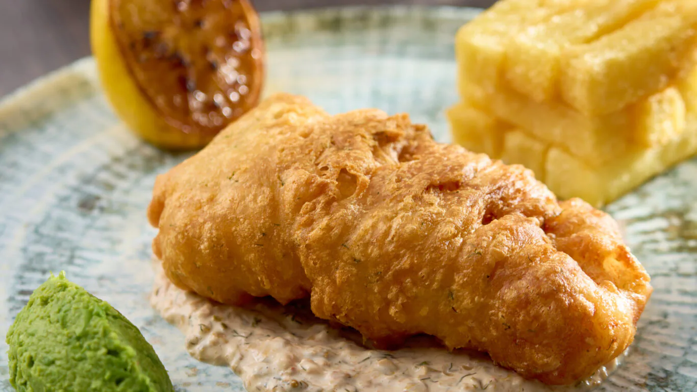 Enjoy gourmet fish and chips with mushy peas at our hotel restaurant, offering delicious British cuisine and exquisite dining.