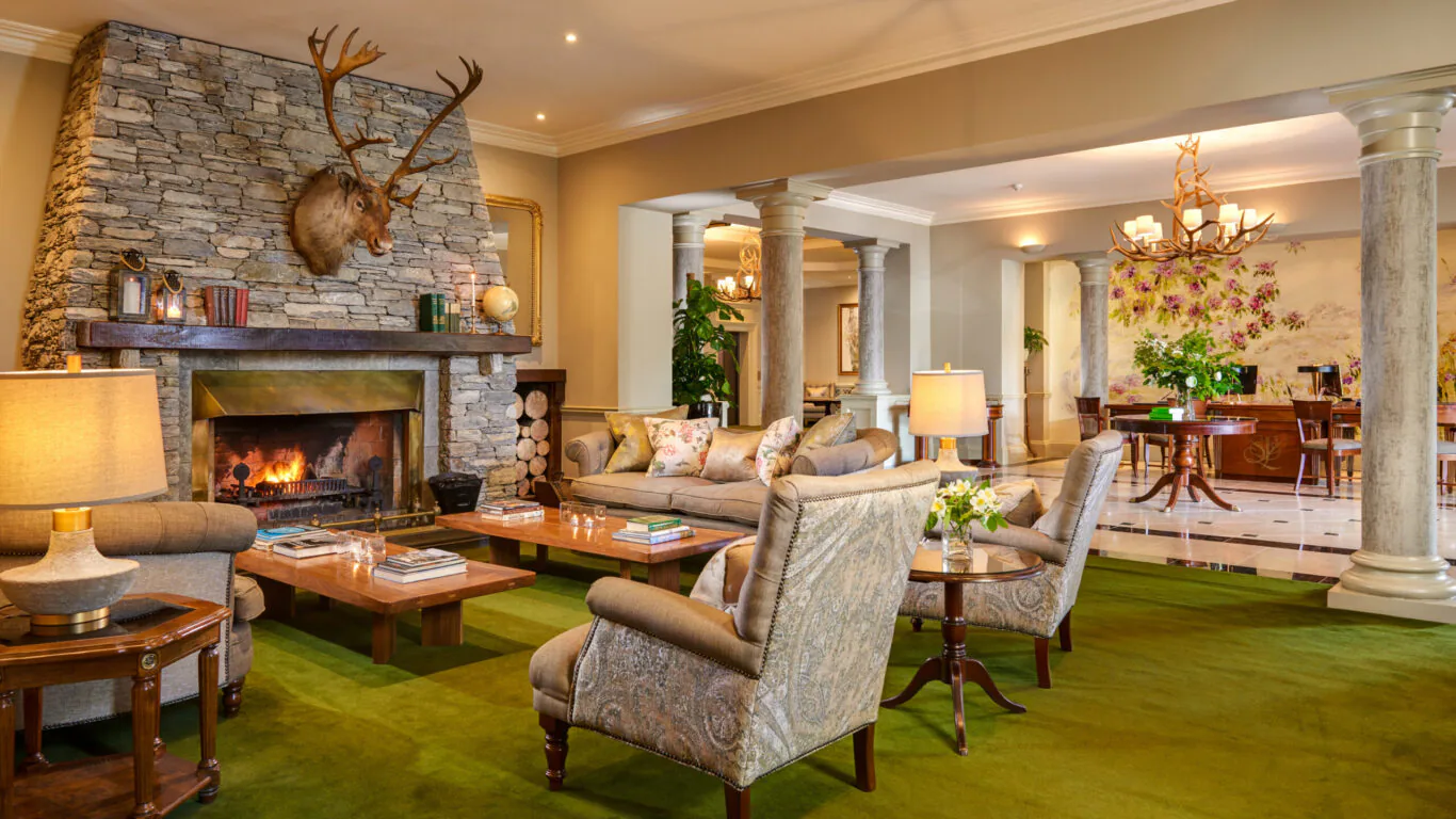 Relaxing hotel lounge with cosy fireplace, elegant seating, and warm lighting, perfect for unwinding after a day of exploring.